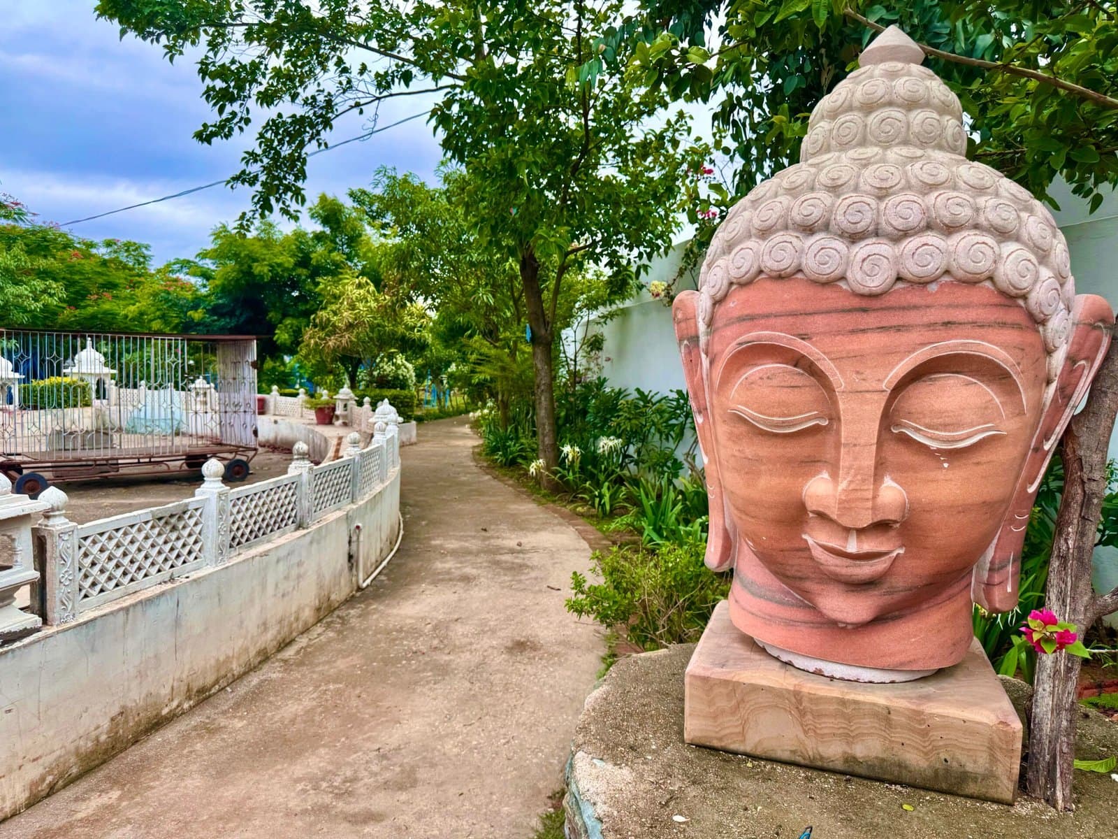 A carved stone Buddha head in the gardens of Anantpuram