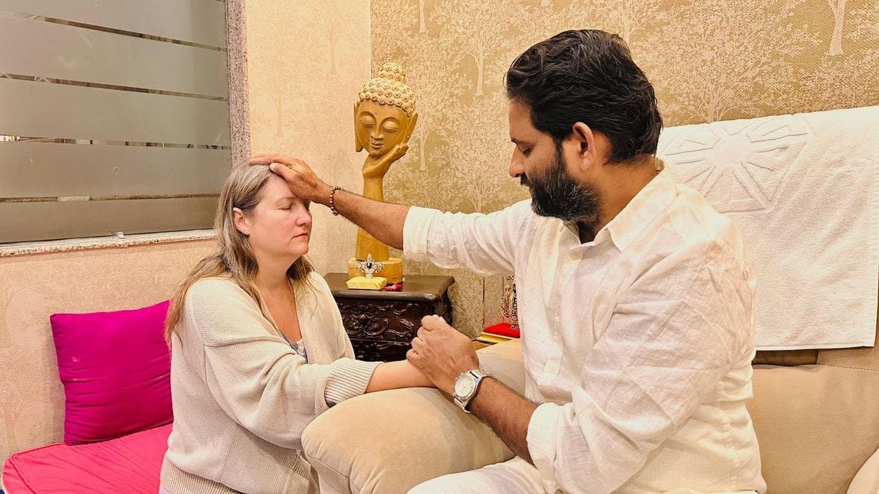 Dr. D.P. Shukla offering healing to a visitor