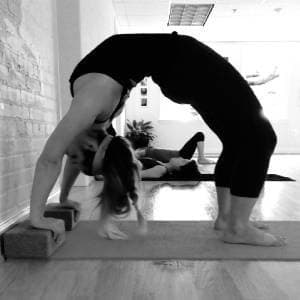 A practitioner in a supported backbend using yoga blocks