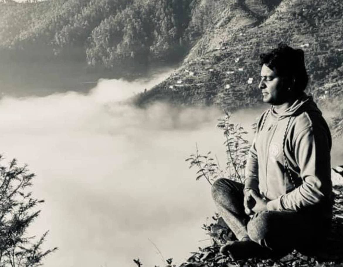 A meditator above a valley of mist