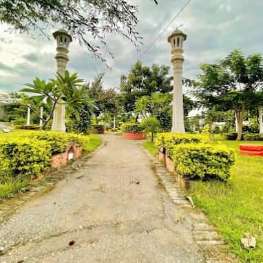 A path between two tall white pillars