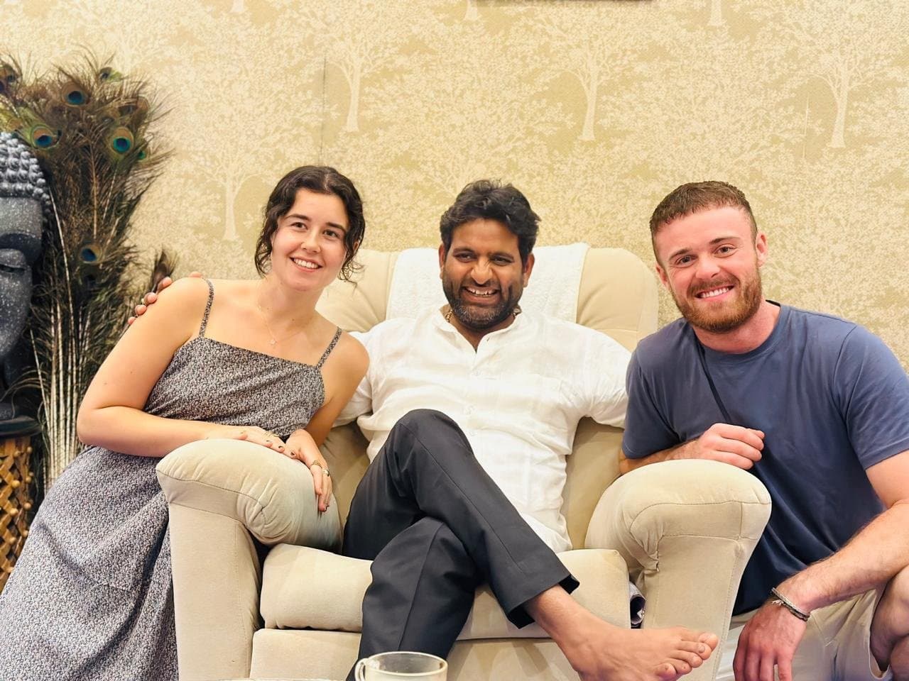Dr. D.P. Shukla seated between two smiling visitors